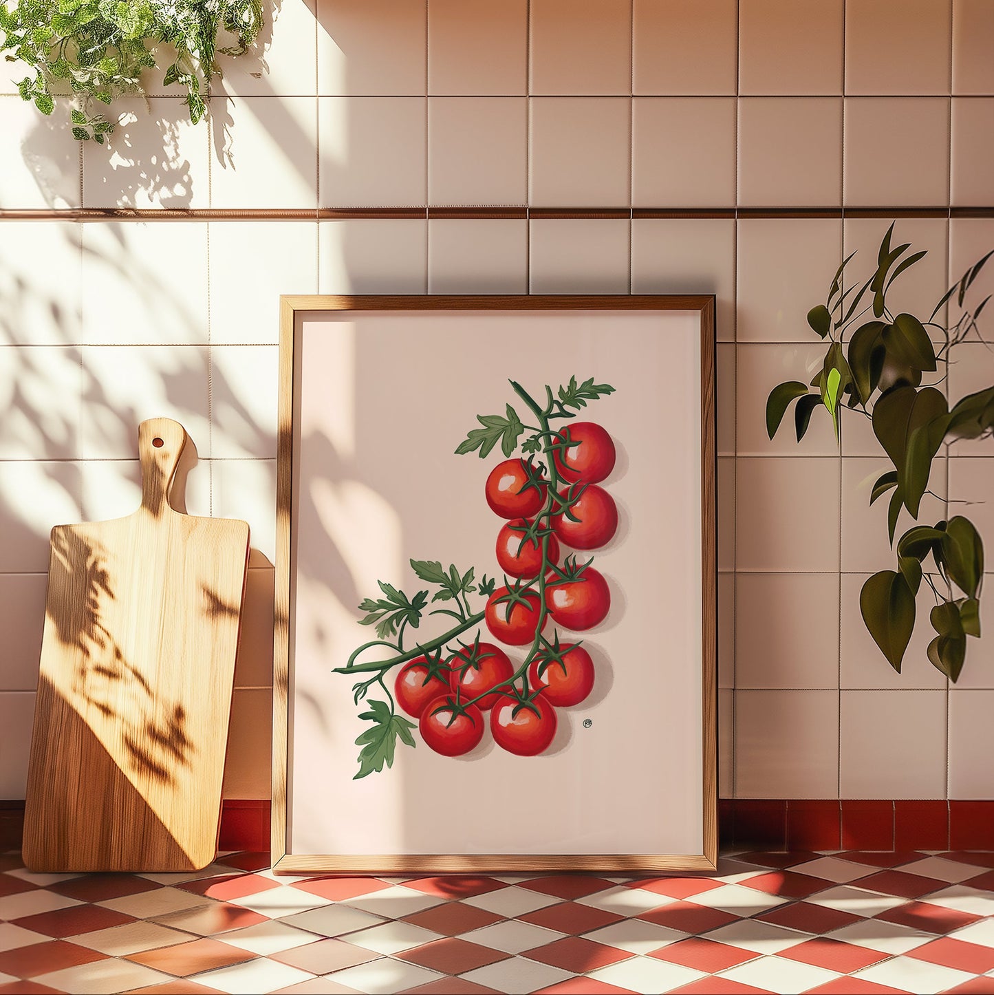 Framed artwork of tomatoes on a kitchen wall with a cutting board and plants.
