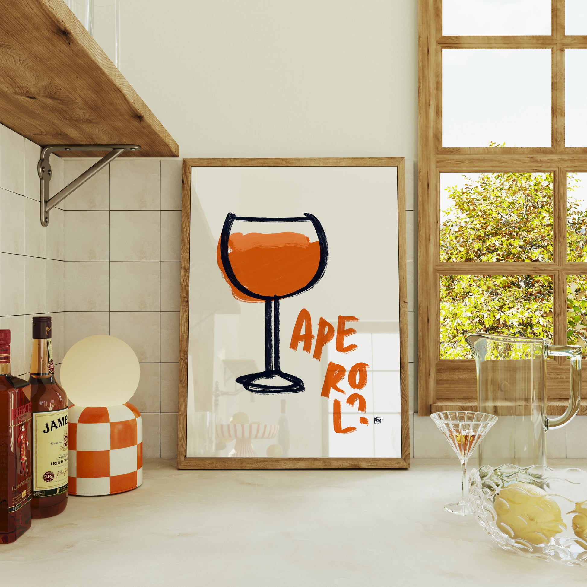 Framed artwork with a glass of Aperol in a kitchen setting