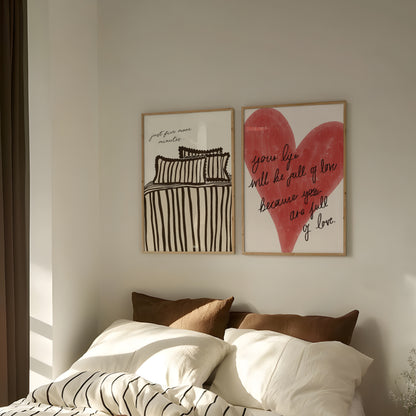 Two framed bedroom artworks on a wall above a bed with pillows.