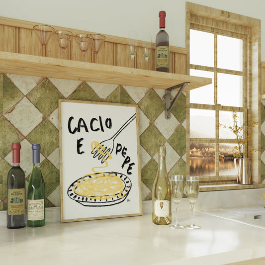 Kitchen counter with wine bottles, a glass, a framed picture of a cacio e pepe spaghetti print, and a window view.