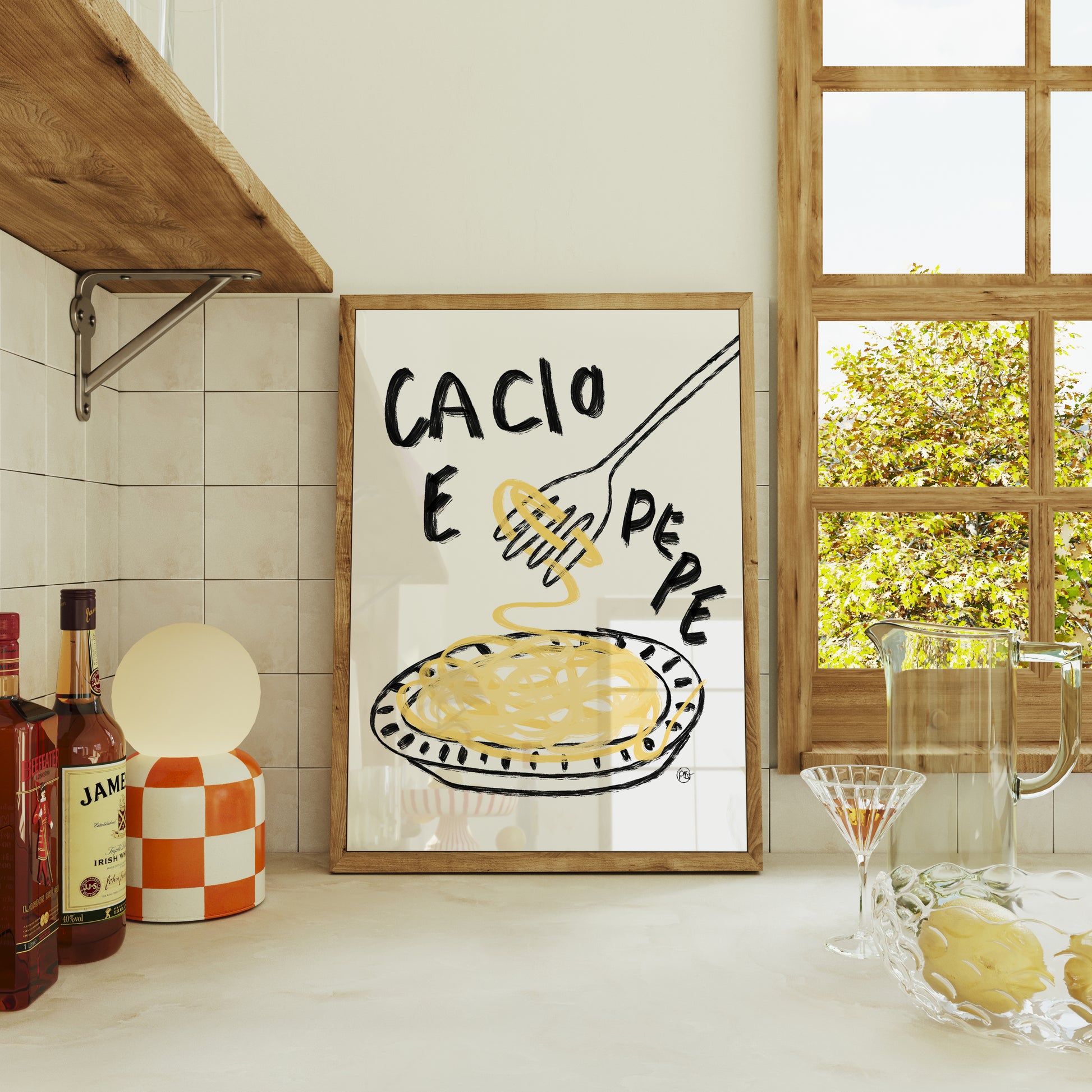 Kitchen interior with a framed poster of 'Cacio E Pepe' on a tiled wall.