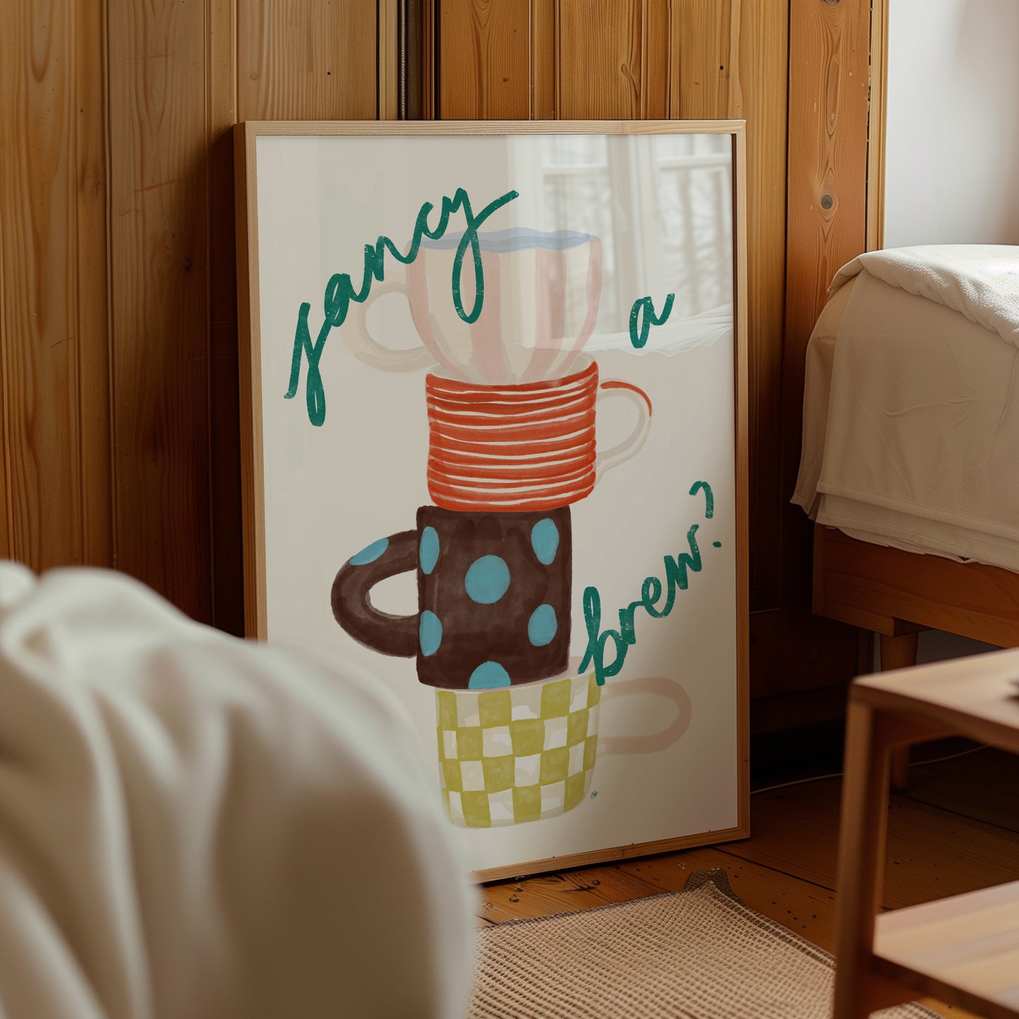 framed artwork of four colourful mugs and fancy a brew text in a nordic style wooden bedroom