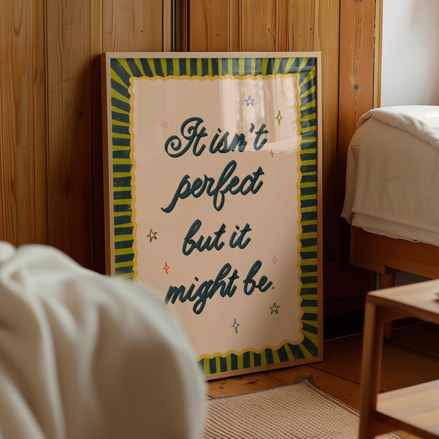Framed motivational poster with text in a room with wooden walls and furniture.