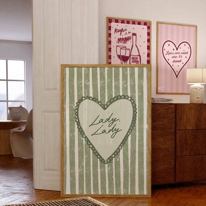 three framed artworks with a heart design and lyrics in a room setting.