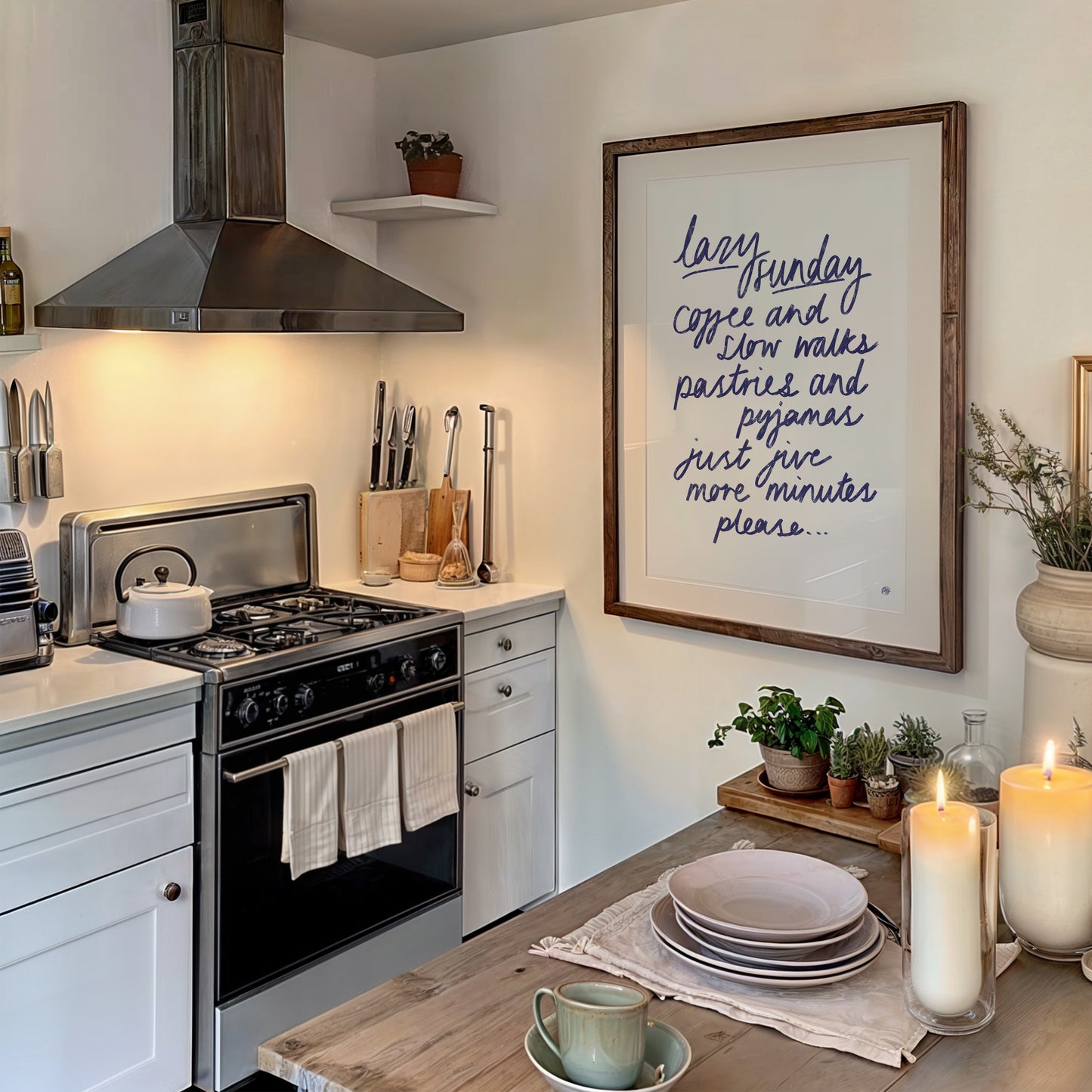 Cozy kitchen with a framed quote, candles, and a cup on a wooden table.