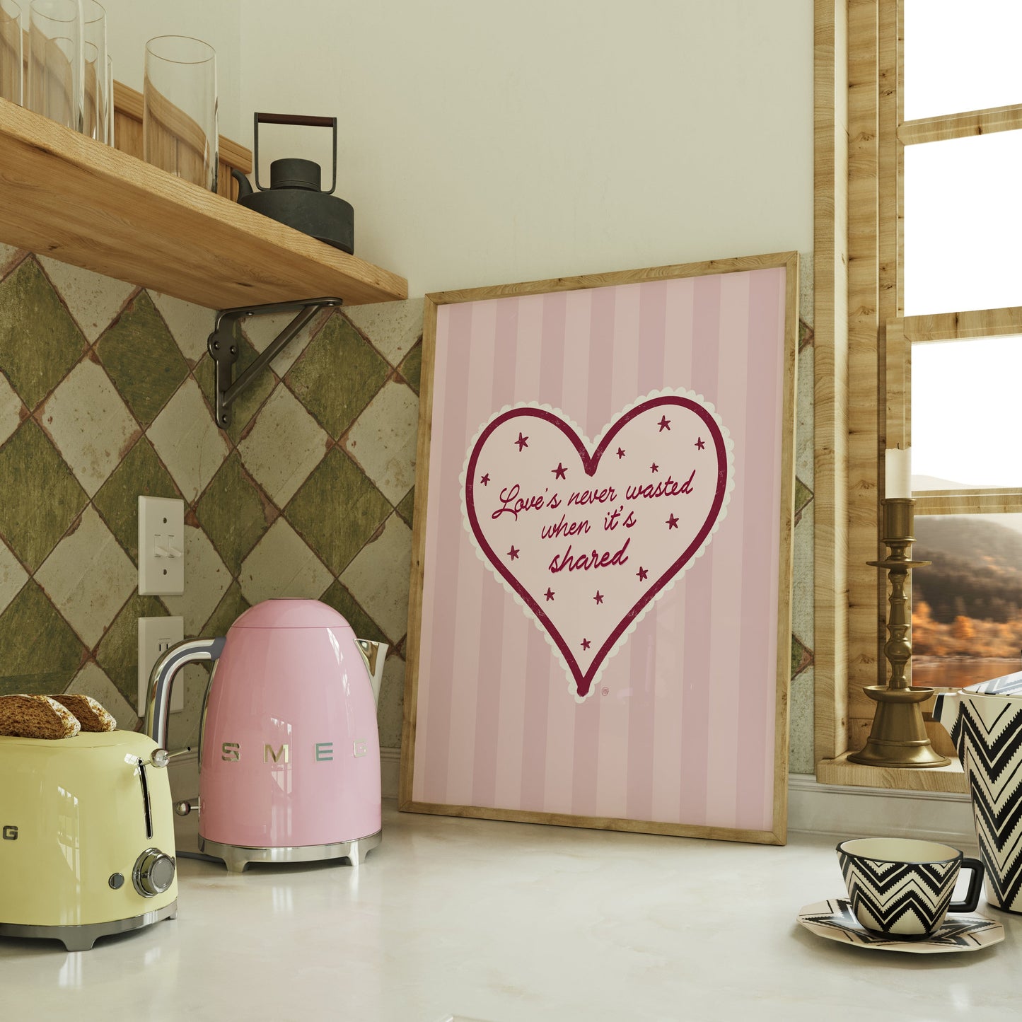 Kitchen counter with pink kettle, yellow toaster, and framed heart artwork.