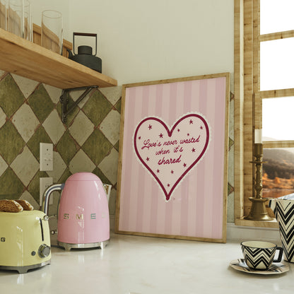 Kitchen counter with pink kettle, yellow toaster, and framed heart artwork.