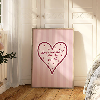 Framed heart-shaped artwork with text on a wall in a bedroom.