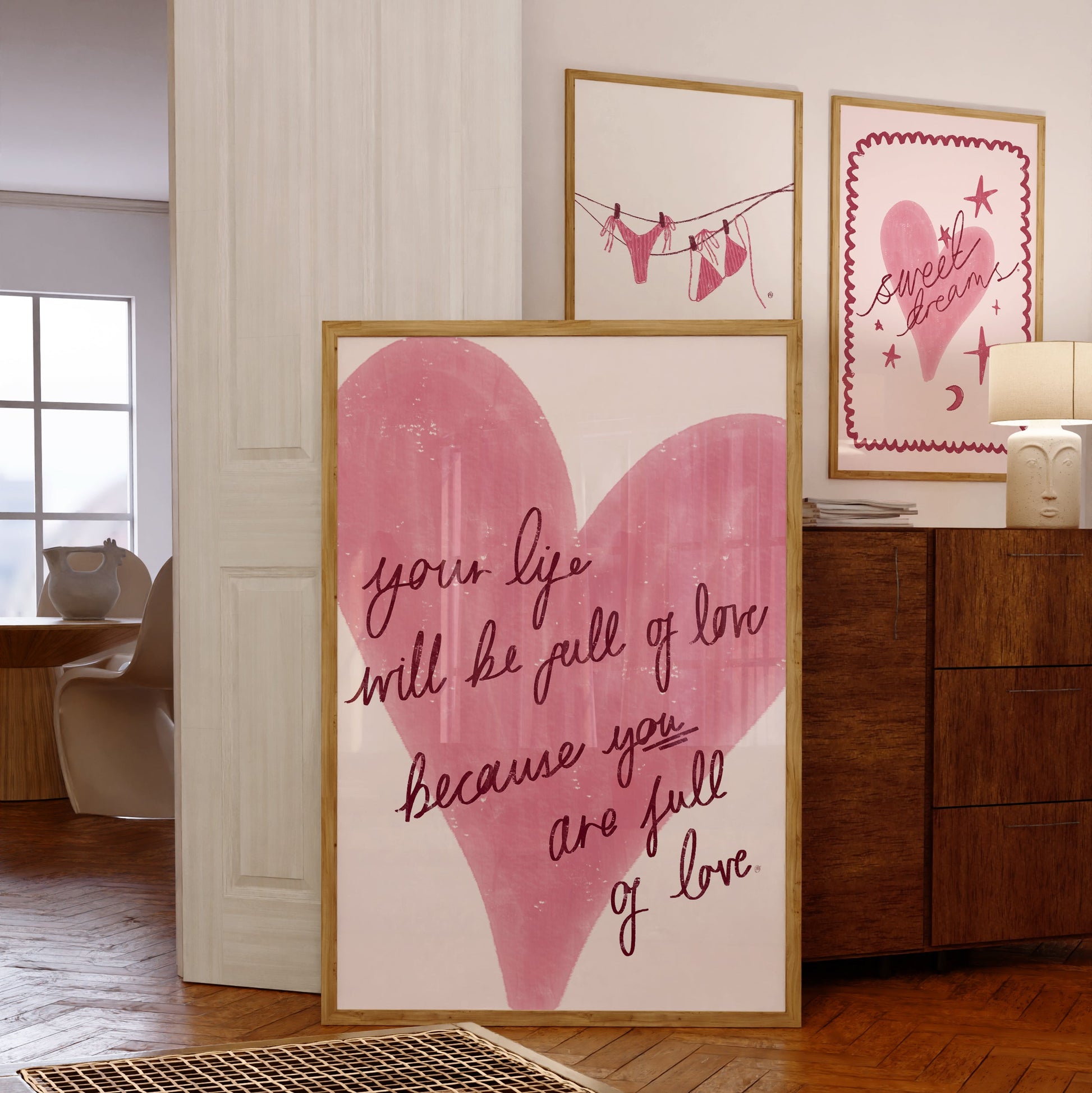 Framed bedroom and bathroom artwork with heart design and motivational quote in a home setting
