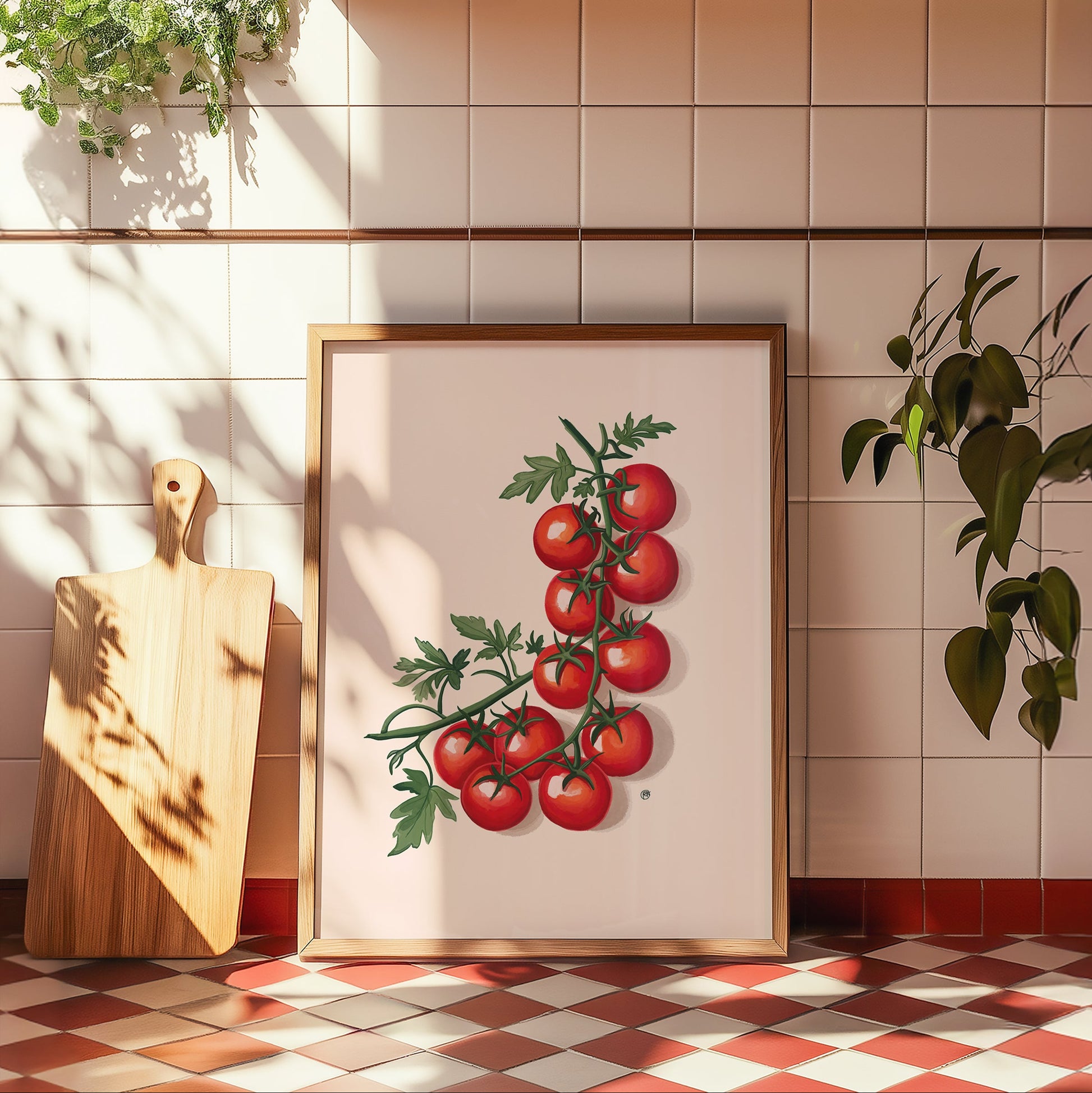 Framed artwork of tomatoes on a kitchen wall with a cutting board and plants.