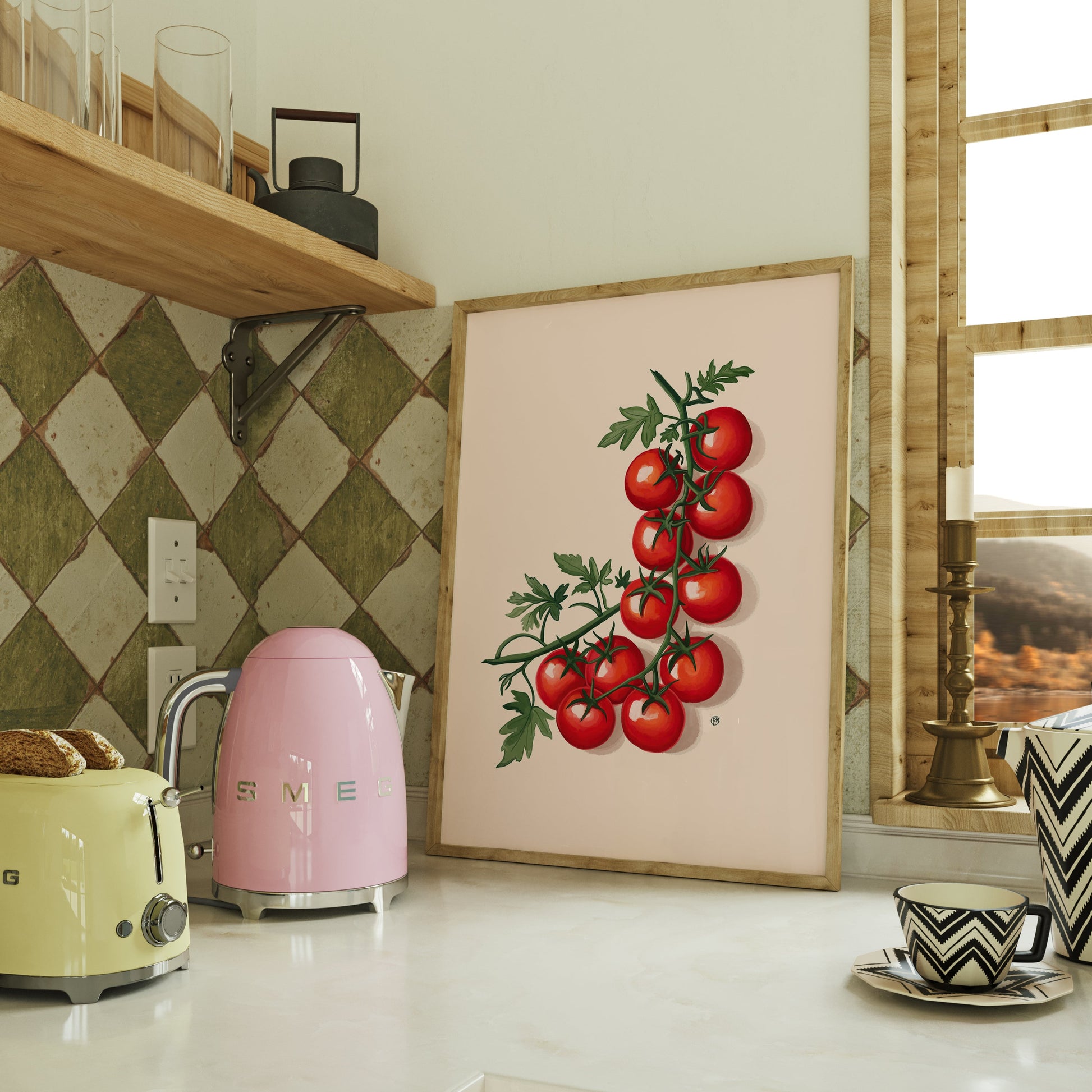 Kitchen counter with a pink appliance, yellow toaster, and framed artwork of tomatoes.