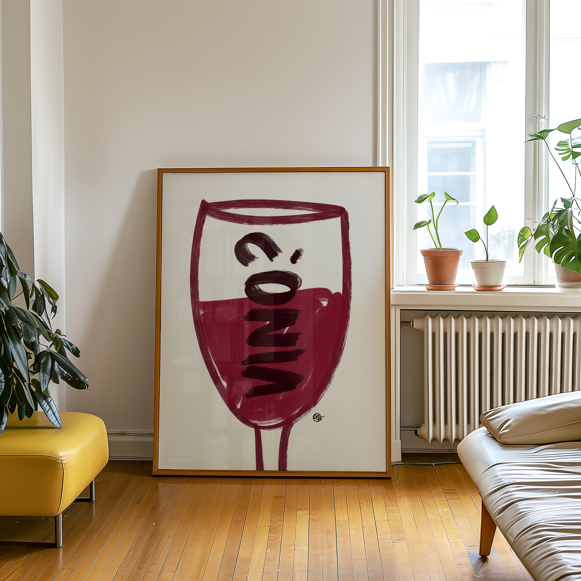 Framed abstract artwork of a wine glass in a living room setting with plants and furniture.