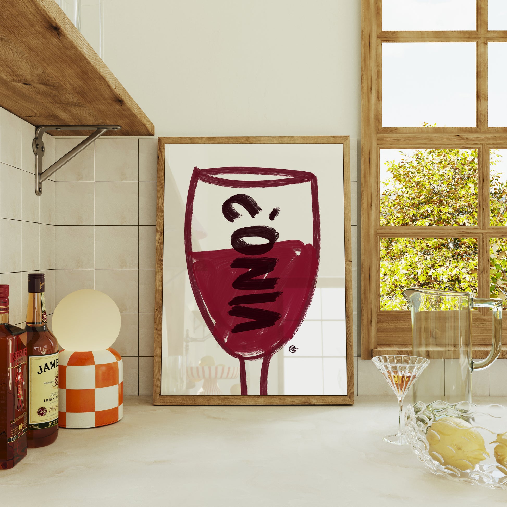 Framed artwork of a wine glass with the word 'Vino' in a kitchen setting.